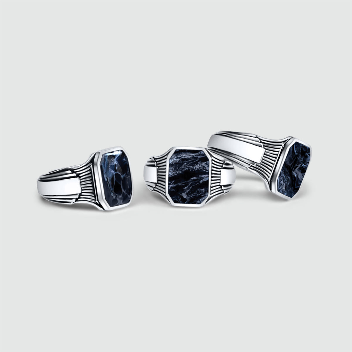 Three Bariq sterling silver mens signet rings shown at different angles on a white background.