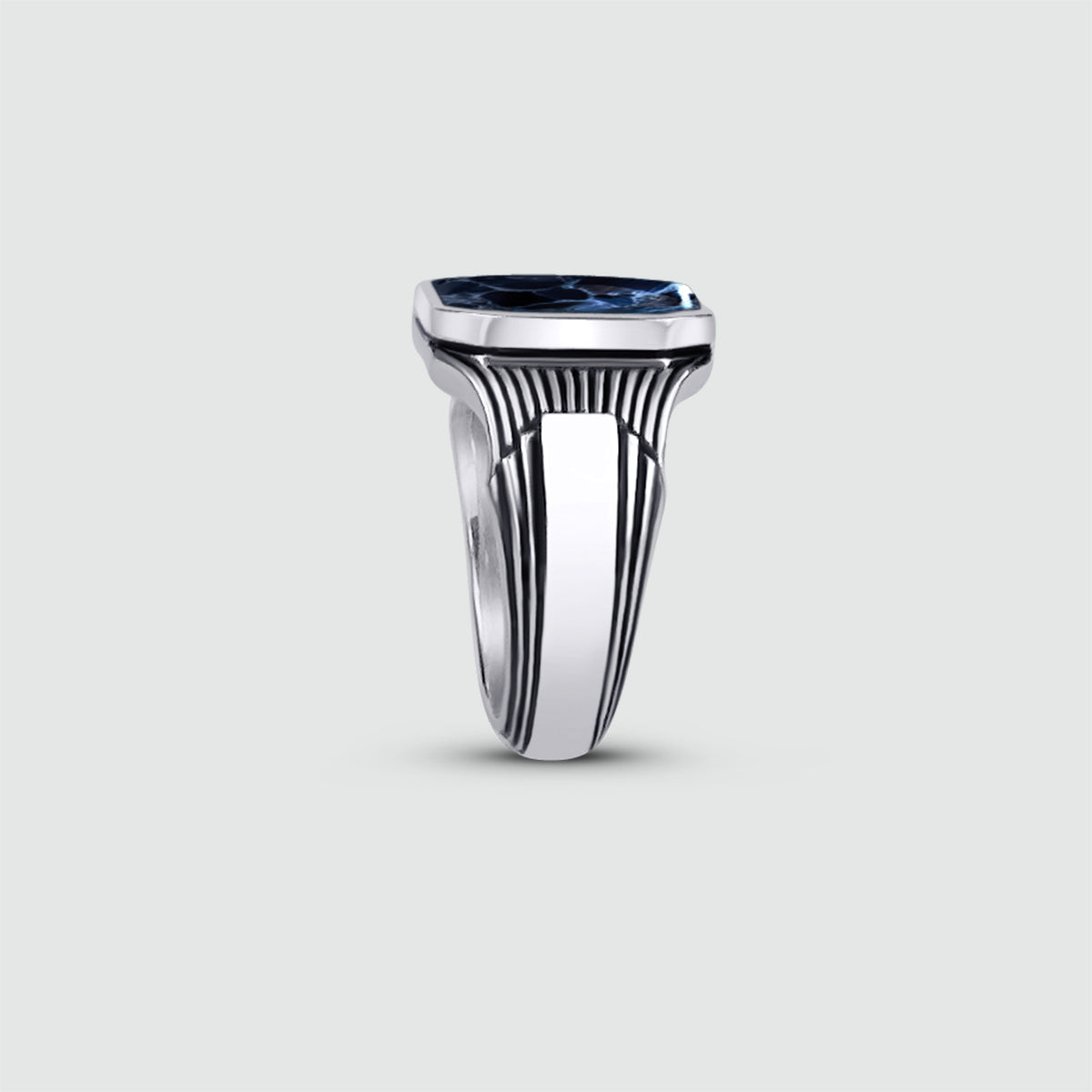 Bariq sterling silver mens ring standing vertical to show the handmade design of the ring.